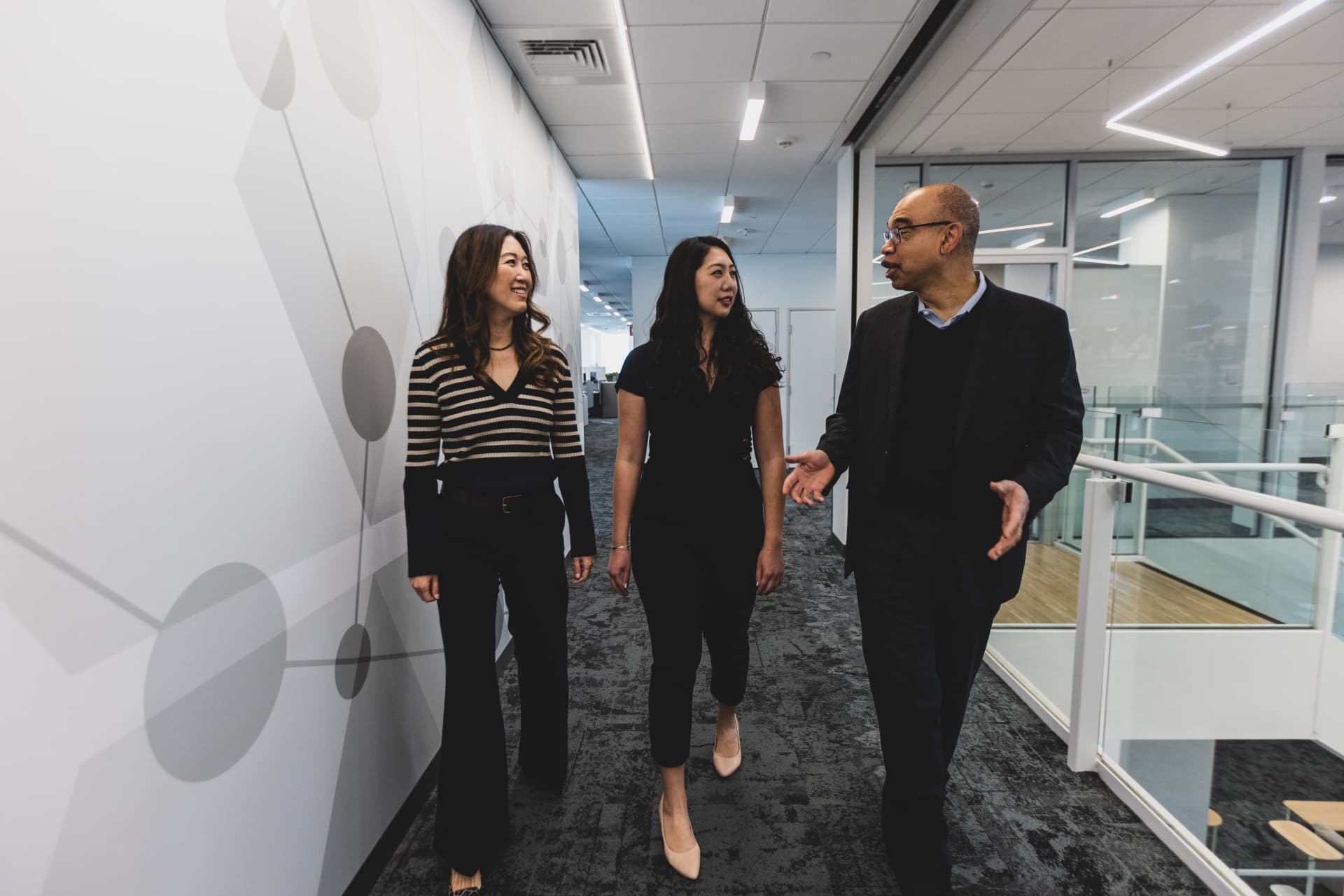 Julie Kim, president of the US business unit and US country head at Takeda, Mimi Yen, a MassNextGen alum, and Kirk Taylor, president and CEO of the Massachusetts Life Sciences Center, take a stroll through one of Takeda’s offices in Cambridge, Mass.